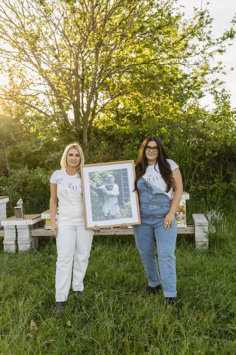 The two sisters holding a photograph of their grandfather, Gino Maio